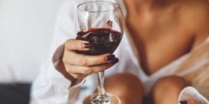 woman holding glass of red wine